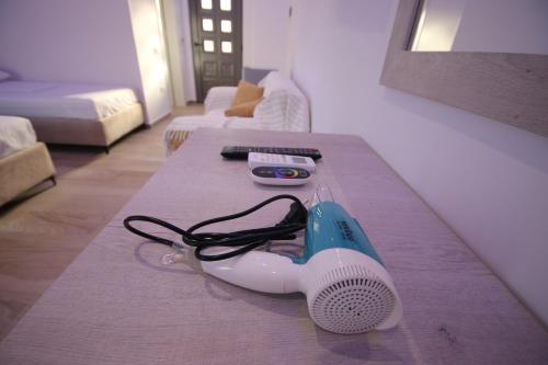 a hair dryer on a table in a living room at Bujtina Eleni in Himare