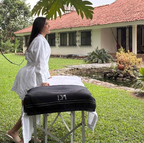 a woman sitting on a table with a pillow at Doral House Villavicencio in Villavicencio