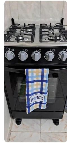 a stove top oven with a blue and white towel on it at Mobay Oasis in Montego Bay