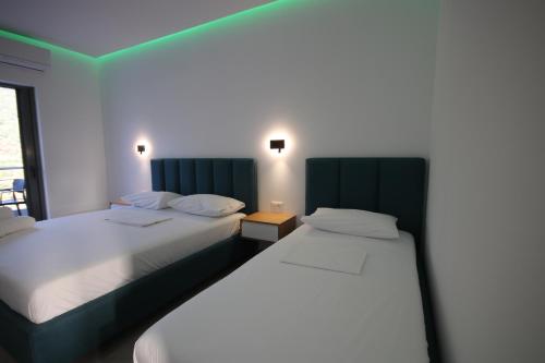 two beds sitting next to each other in a room at Bujtina Eleni in Himare