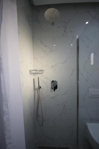 a bathroom with a shower and a sink at Bujtina Eleni in Himare