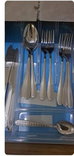 a group of utensils in a drawer with a spoon at Mobay Oasis in Montego Bay