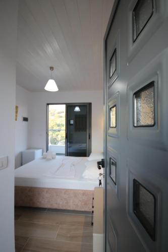 a bedroom with a large bed and a window at Bujtina Eleni in Himare