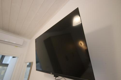 a large flat screen tv hanging on a wall at Bujtina Eleni in Himare