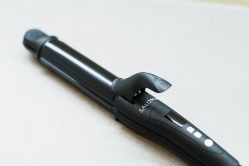 a black flashlight sitting on a white surface at Flower Base HIMAWARI in Fukuoka