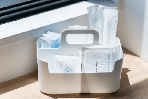 a white container sitting on the floor next to a window at Flower Base HIMAWARI in Fukuoka
