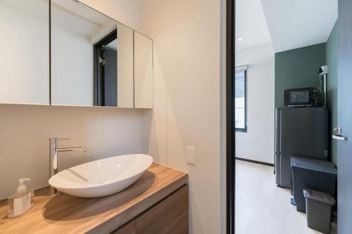 a bathroom with a white bowl sink on a counter at Flower Base HIMAWARI in Fukuoka