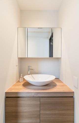 a bathroom with a white sink and a mirror at Flower Base HIMAWARI in Fukuoka
