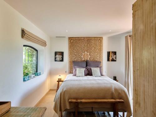 une chambre avec un grand lit et une fenêtre dans l'établissement Magnificent villa - AC- 5BR-12P- Ramatuelle, à Ramatuelle