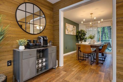 a kitchen and dining room with a table and a mirror at The Mountain Muse - Music, Games, HotTub, Sleeps12, PetsOk in McGaheysville