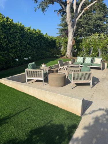 a group of chairs and tables on a patio at Montecito-Chic Beachside Retreat in Montecito