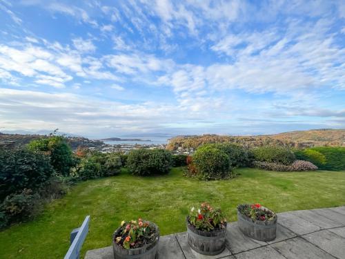 a view of a yard with flowers in pots at Kiloran in Oban