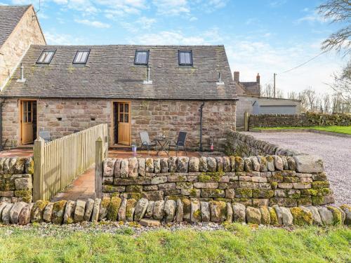 a stone house with a stone wall in front of it at Jacob's Barn - Uk46733 in Wootton