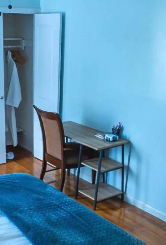 a wooden table and chairs in a room with a blue rug at Abundant Seed in Rosedale