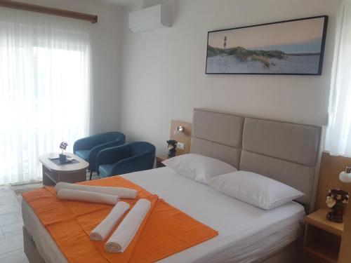 a bedroom with a bed with two towels on it at Wendy in Budva