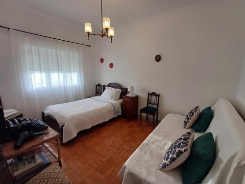 a living room with two beds and a couch at Casa da Tia Lena in Coimbra
