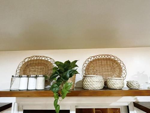 a shelf with three baskets and a plant on it at C&G Staycation Home in General Trias