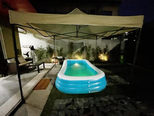 a blue inflatable swimming pool under a tent at C&G Staycation Home in General Trias
