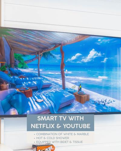 a tv screen with a picture of a beach at AZURE NORTH BEACH RESORT at HANEUL SANDS in San Fernando