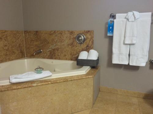 a bathroom with a tub and towels on a wall at Bel Abri Napa Valley Inn in Napa