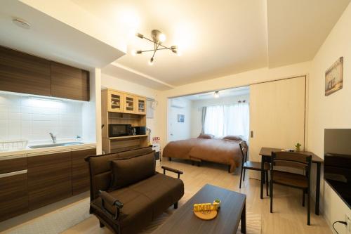 a living room with a kitchen and a bedroom at Laguna Verde Miyanosawa 102 in Sapporo