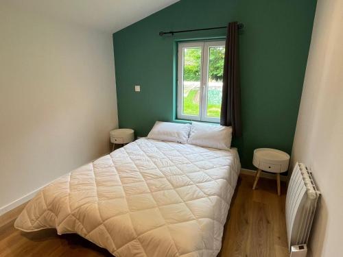 a small bedroom with a bed and a window at Maison Vacances 4 Pers à Pontenx-Les-Forges - Proche Océan et Forêt - FR-1-50-185 in Pontenx-les-Forges