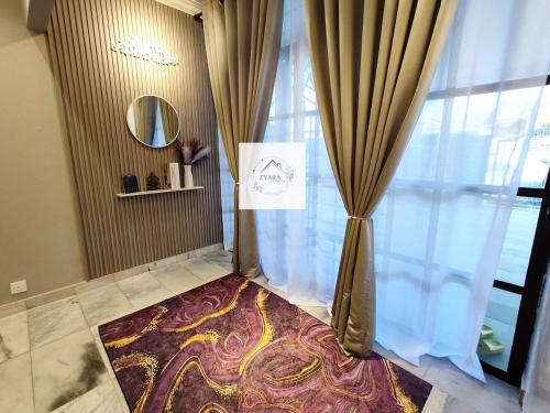 a room with a curtain and a rug next to a window at Zyara Homestay Seremban in Seremban