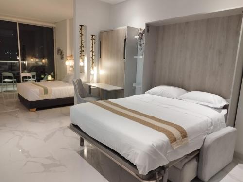 Una cama o camas en una habitación de Patty del Mar Suites