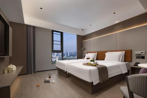 Ein Bett oder Betten in einem Zimmer der Unterkunft All-weather Hotel Wutian Old Street Branch