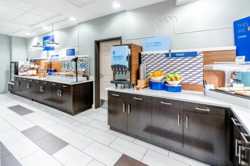 a store with wooden cabinets and counters in a store at Holiday Inn Express & Suites Denver North - Thornton by IHG in Thornton