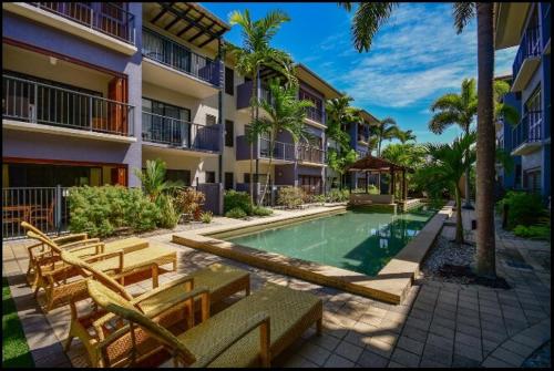 a swimming pool in front of a building at Cairns Central Atrium Apartments & Studio in Cairns