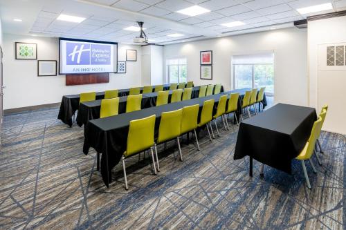 a conference room with black tables and yellow chairs at Holiday Inn Express & Suites Denver North - Thornton by IHG in Thornton
