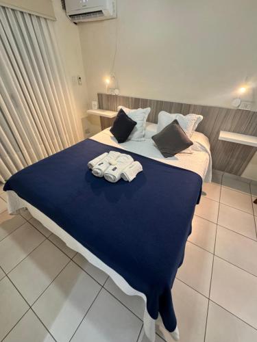 a bedroom with a bed with towels on it at ApartSur Santa Fe in Santa Fe