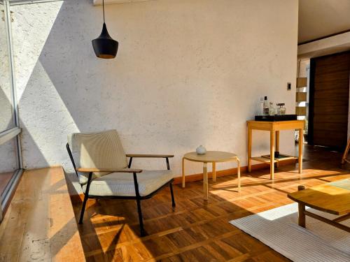 a living room with a chair and a table at Villa Florita in La Paz