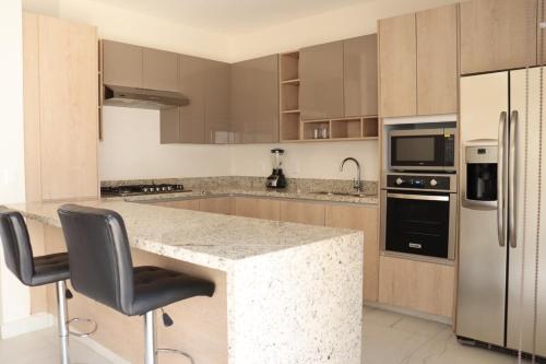 a kitchen with a granite counter top and appliances at Privada, Casa Real Flamingos , Nayarit in Bucerías