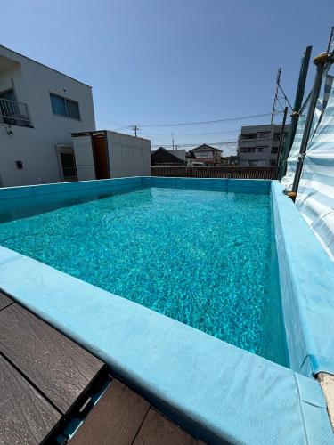a swimming pool with blue water on top of a building at condominium [Signal Resort] in Kujukuri
