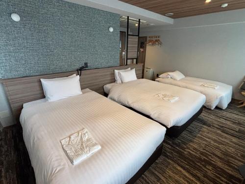 Ένα ή περισσότερα κρεβάτια σε δωμάτιο στο Fukuoka Toei Hotel