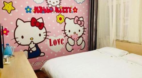 a bedroom with a wall with hello kitty painted on it at Super 8 Hotel Jinan Railway Station Square in Jinan