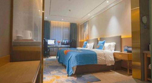 a bedroom with a bed and a desk in it at Quanzhou Binhai Hotel in Quanzhou