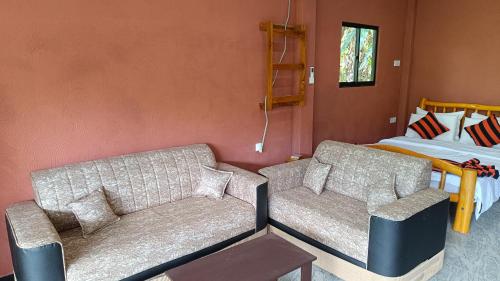 a living room with a couch and a bed at Forest Rawana homestay Ella in Ella