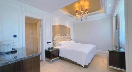 a white bedroom with a bed and a mirror at Tongxiang Inspirock Hotel in Jiaxing