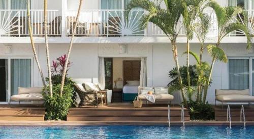 a hotel with a swimming pool in front of a building at EXCELLENCE PUNTA CANA - ALL INCLUSIVE - ADULTS ONLY in Punta Cana