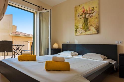 a large bed in a bedroom with a large window at Residence Club El Paraiso in Sa Ràpita