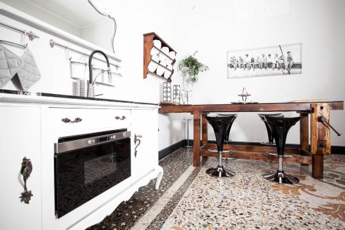 a kitchen with a table and a dining room at Residenza Bendinelli-Sauli in Genova