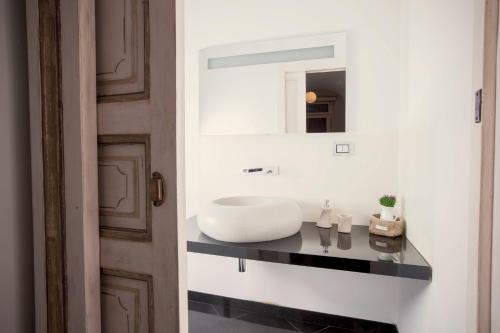 a bathroom with a white sink and a mirror at Residenza Bendinelli-Sauli in Genova