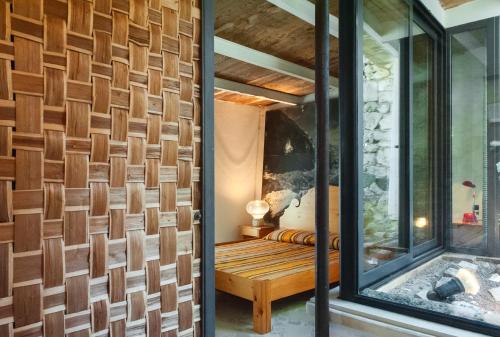 a room with a bench and a wall of windows at Limonaia in Salento in Marittima