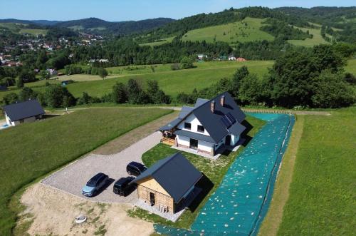 an aerial view of a house with a river at Słońce i cień in Baligród