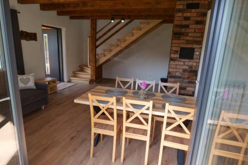 a dining room with a table and some chairs at Słońce i cień in Baligród
