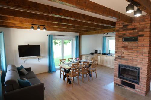 a living room with a table and a fireplace at Słońce i cień in Baligród