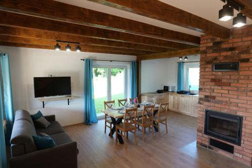 a living room with a table and a fireplace at Słońce i cień in Baligród